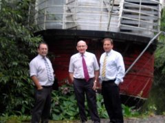 3 surveyors in front of boat